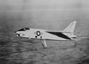 In-flight photograph of John Glenn piloting his F8U-1P Crusader with the air brake lowered for refueling during the "Project Bullet" record breaking transcontinental flight, 1957