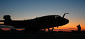 As the Iraqi sun rises, a Marine from Marine Tactical Electronic Warfare Squadron 4 renders the proper salute as one of the squadrons EA-6B Prowlers taxis to the flightline to begin a mission. Photo by Staff Sgt. Robert Jacobson